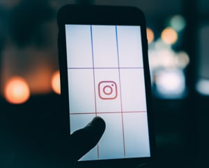 A picture of a smart phone displaying a chart with the Instagram icon in the middle of the screen.