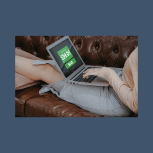 A picture of a woman laying on a brown leather couch with a laptop open and a green graphic displayed with a dollar amount and a button that states "GIVE."