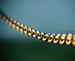 Picture of a chain on a bluish grey background.