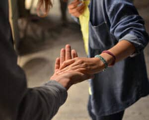 A picture of two people's hands touching.