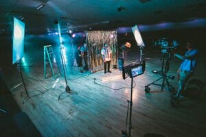 Picture of a sounds stage with lights, cameras, and video recorders capturing a clip for a worship service video.