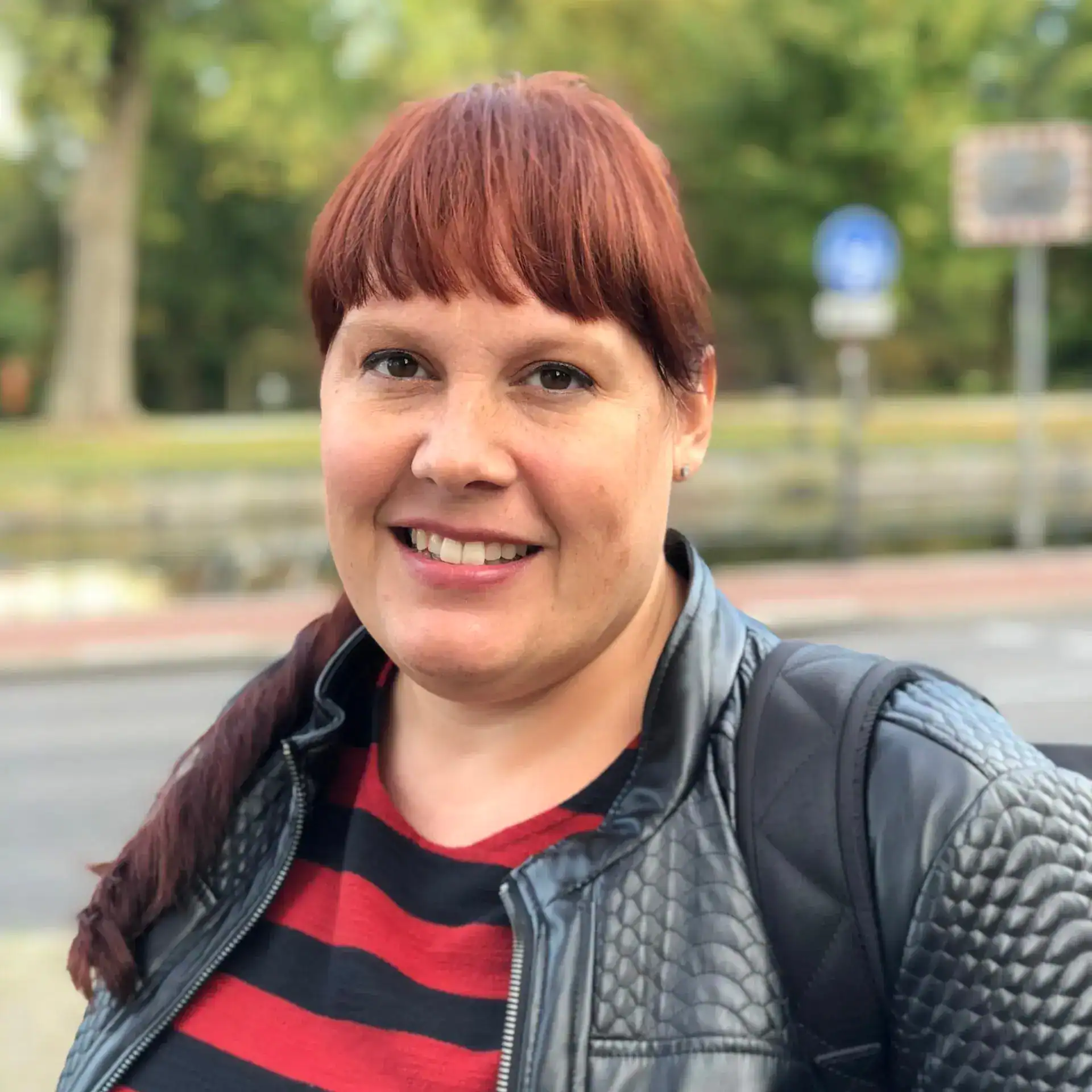 Tamara Daugherty, Communications Director at Trinity Episcopal Church, smiling outdoors.